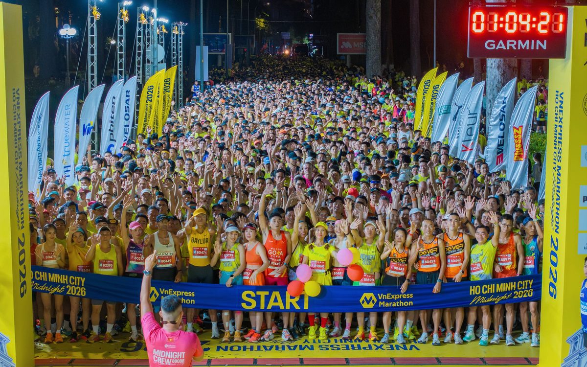 Thousands of runners massed at the start gantry of a city marathon